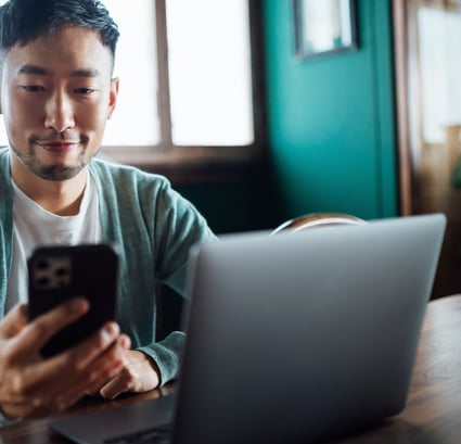 Student Sits in Coffee Shop on Laptop